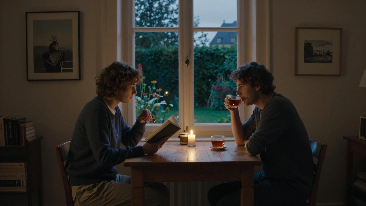 Two people sit quietly at a wooden table in a softly lit apartment, sharing tea and books in a peaceful moment.